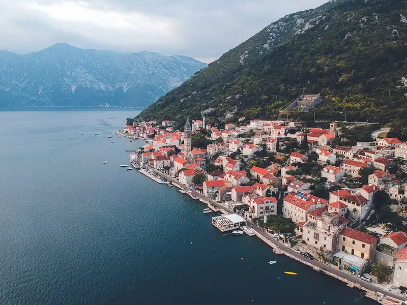 Perast from the water: red roofs and the Bay of Kotor mountains